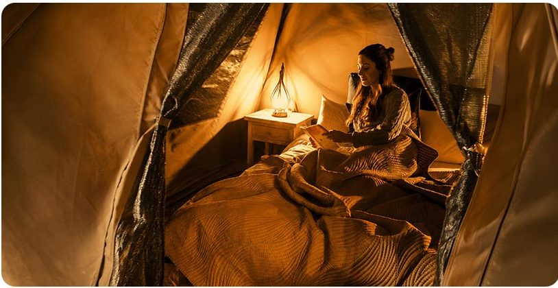 Guest relaxing in a glamping tent